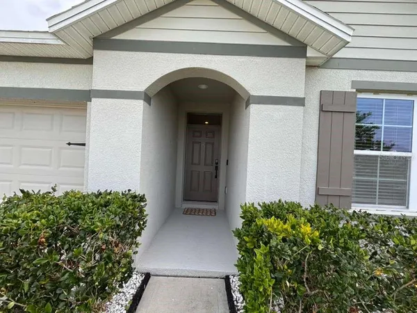 a front view of a house with plants