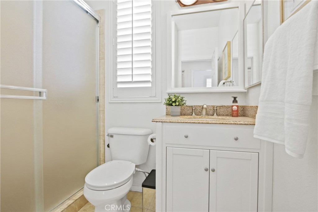 9 Paddock Place Ladera Ranch, CA 92694 - Photo 18 of 25 a bathroom with a granite countertop toilet sink and mirror
