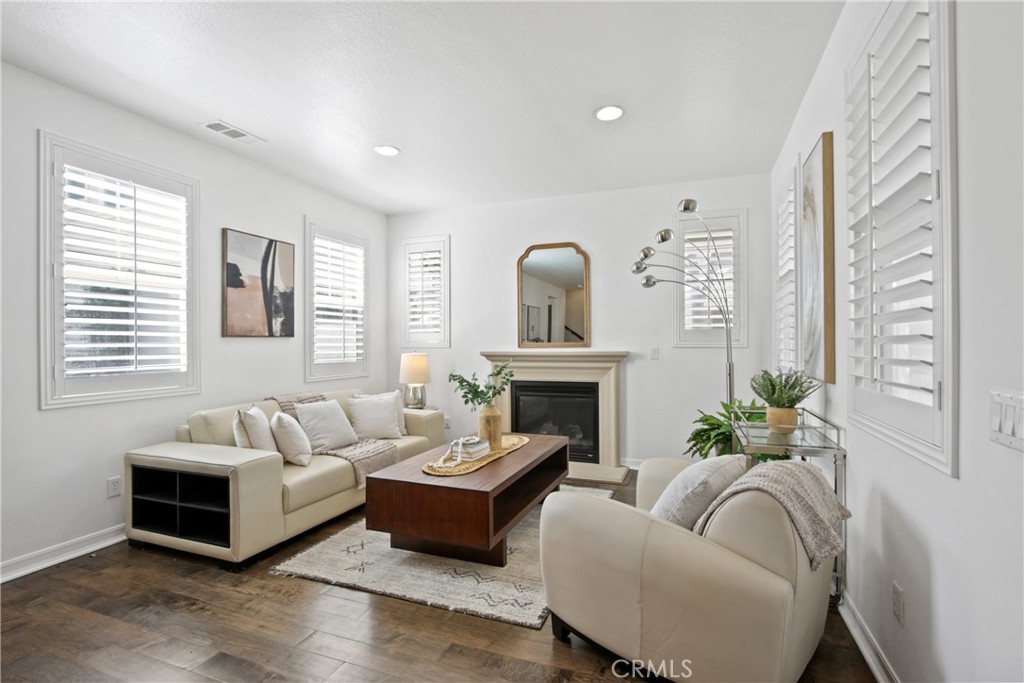 9 Paddock Place Ladera Ranch, CA 92694 - Photo 4 of 25 a living room with furniture a fireplace and a potted plant