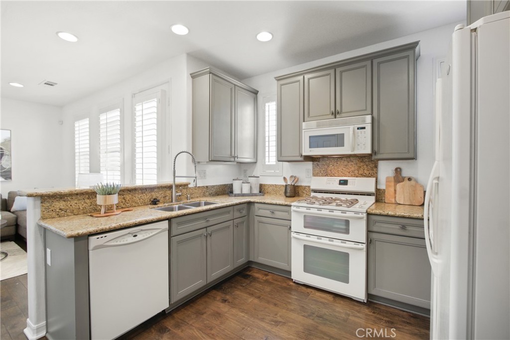9 Paddock Place Ladera Ranch, CA 92694 - Photo 8 of 25 a kitchen with stainless steel appliances granite countertop a sink stove and cabinets