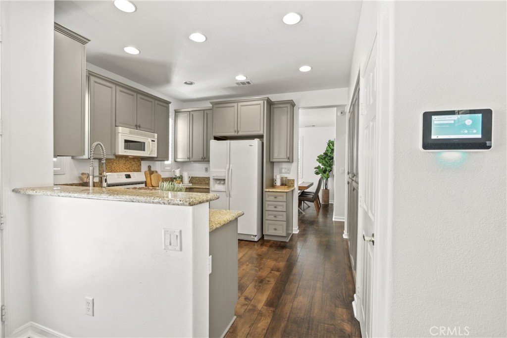 9 Paddock Place Ladera Ranch, CA 92694 - Photo 10 of 25 a kitchen with stainless steel appliances granite countertop a refrigerator a stove and a sink