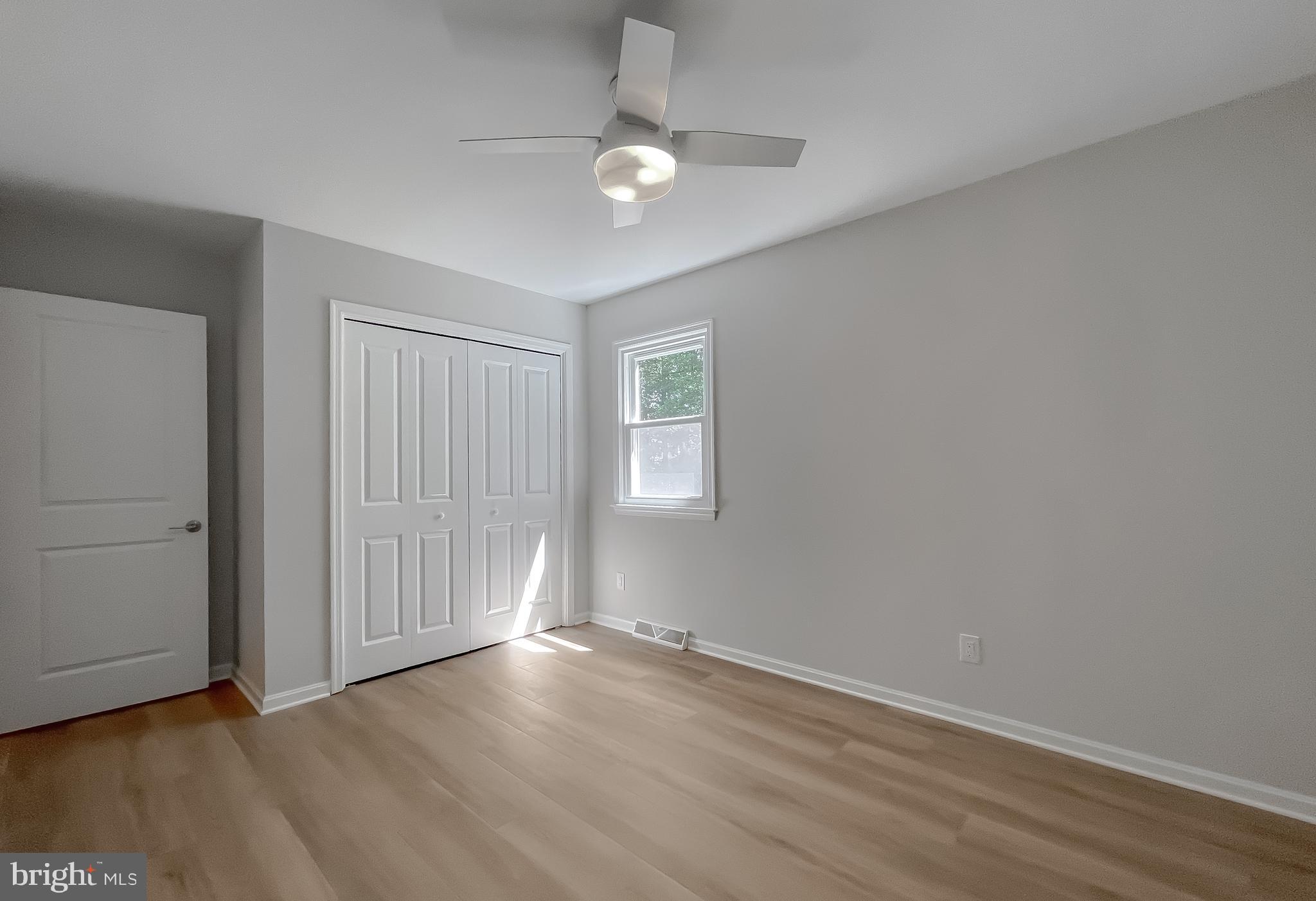 22373 Enoch Road Leonardtown, MD 20650 - Photo 48 of 74 an empty room with wooden floor and windows