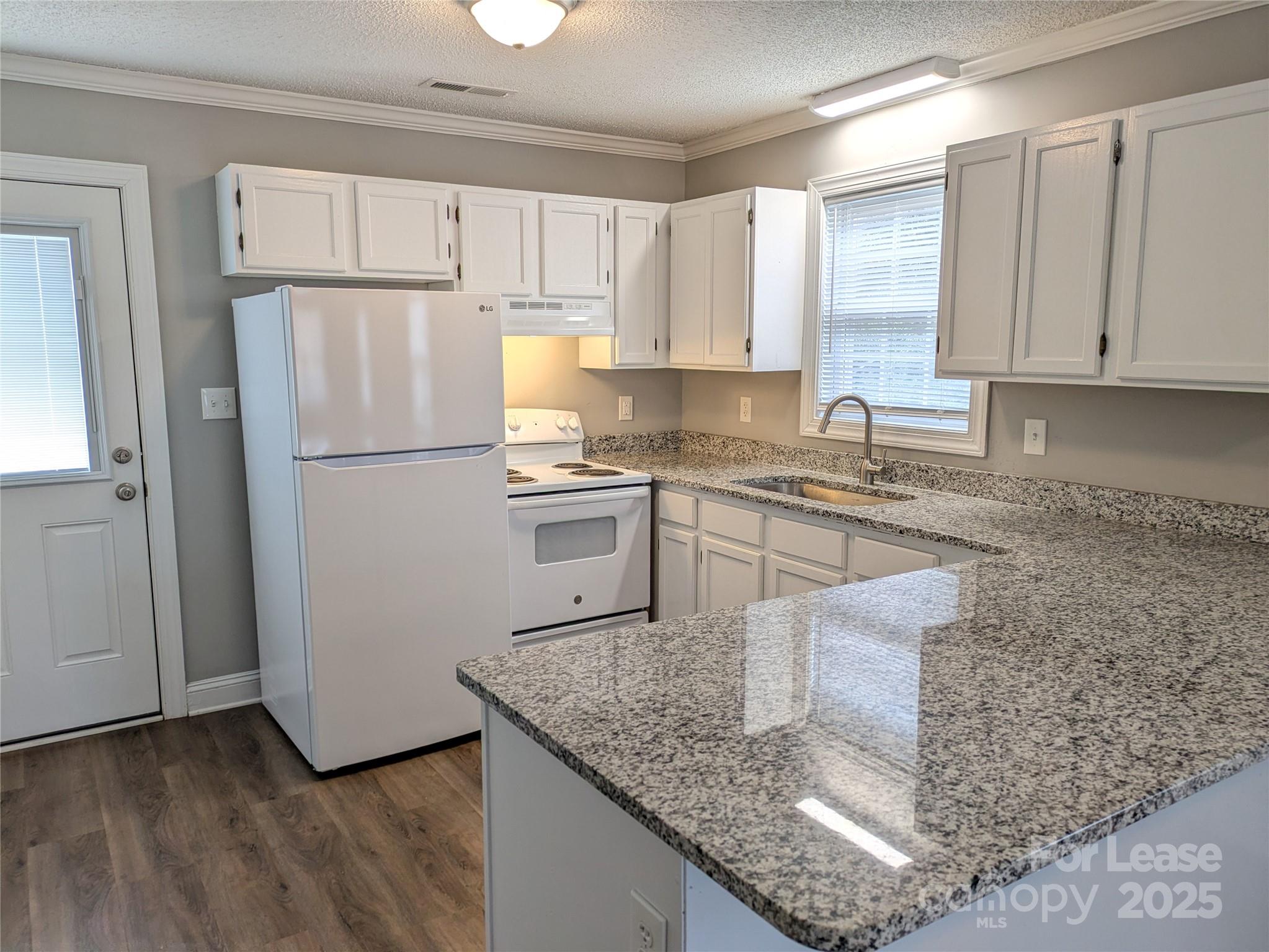 149 McKendree Road Mooresville, NC 28117 - Photo 12 of 21 a kitchen with kitchen island granite countertop a sink a center island stainless steel appliances and cabinets