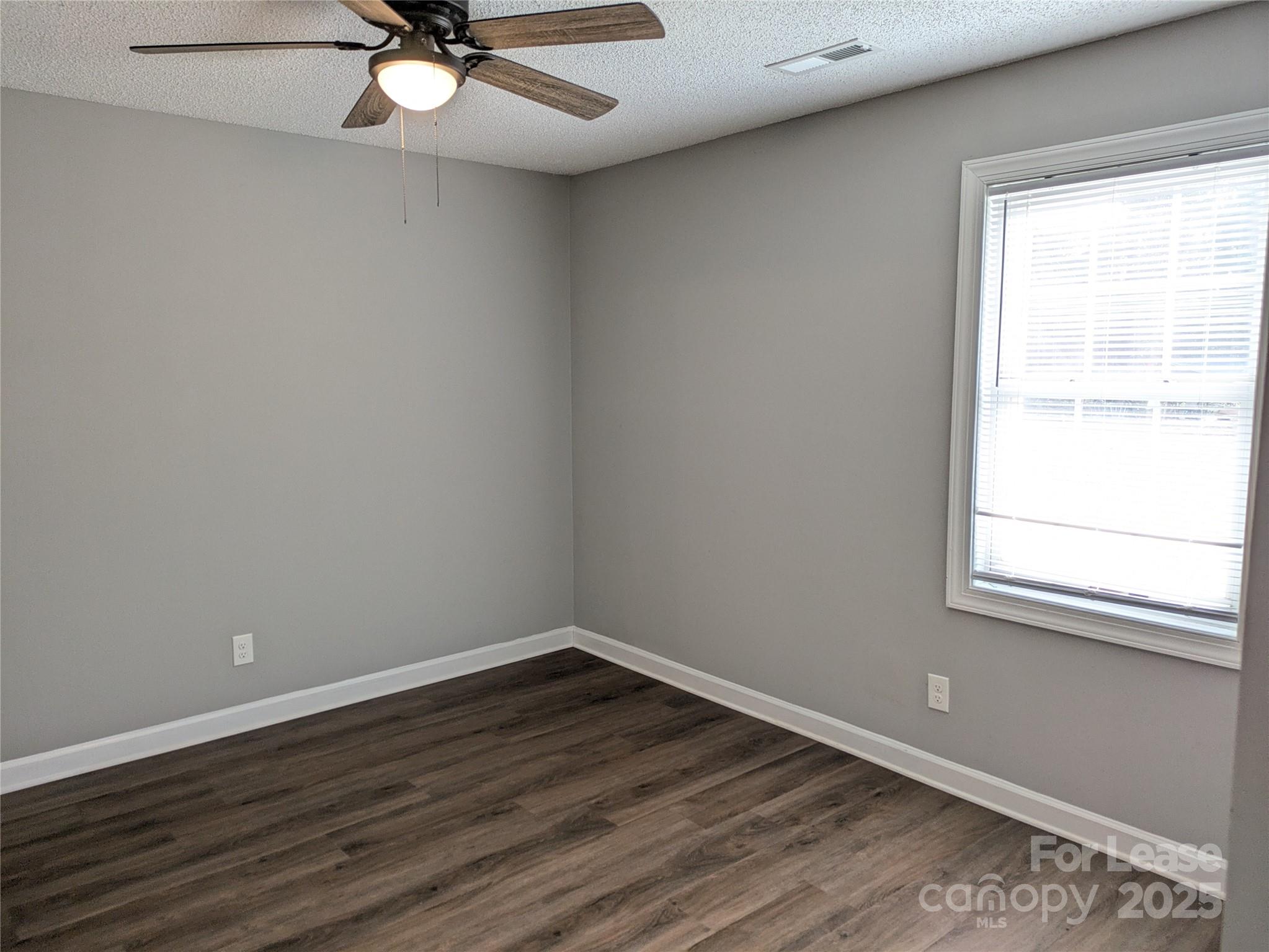 149 McKendree Road Mooresville, NC 28117 - Photo 17 of 21 wooden floor in an empty room with a window