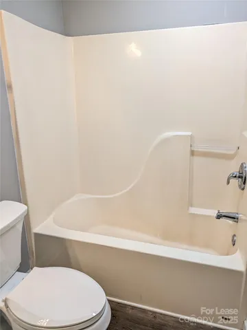 a bathroom with a toilet and a bathtub