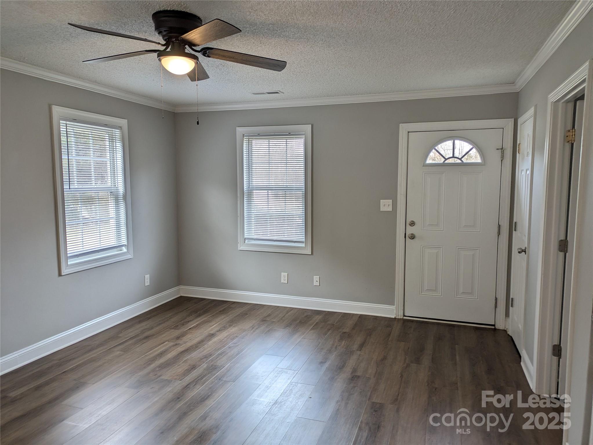 149 McKendree Road Mooresville, NC 28117 - Photo 3 of 21 a view of an empty room with wooden floor and a window