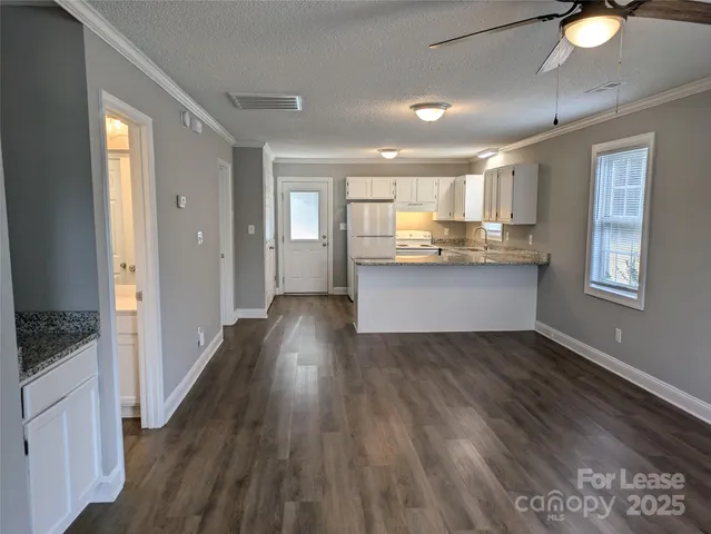 a view of kitchen with sink and wooden floor