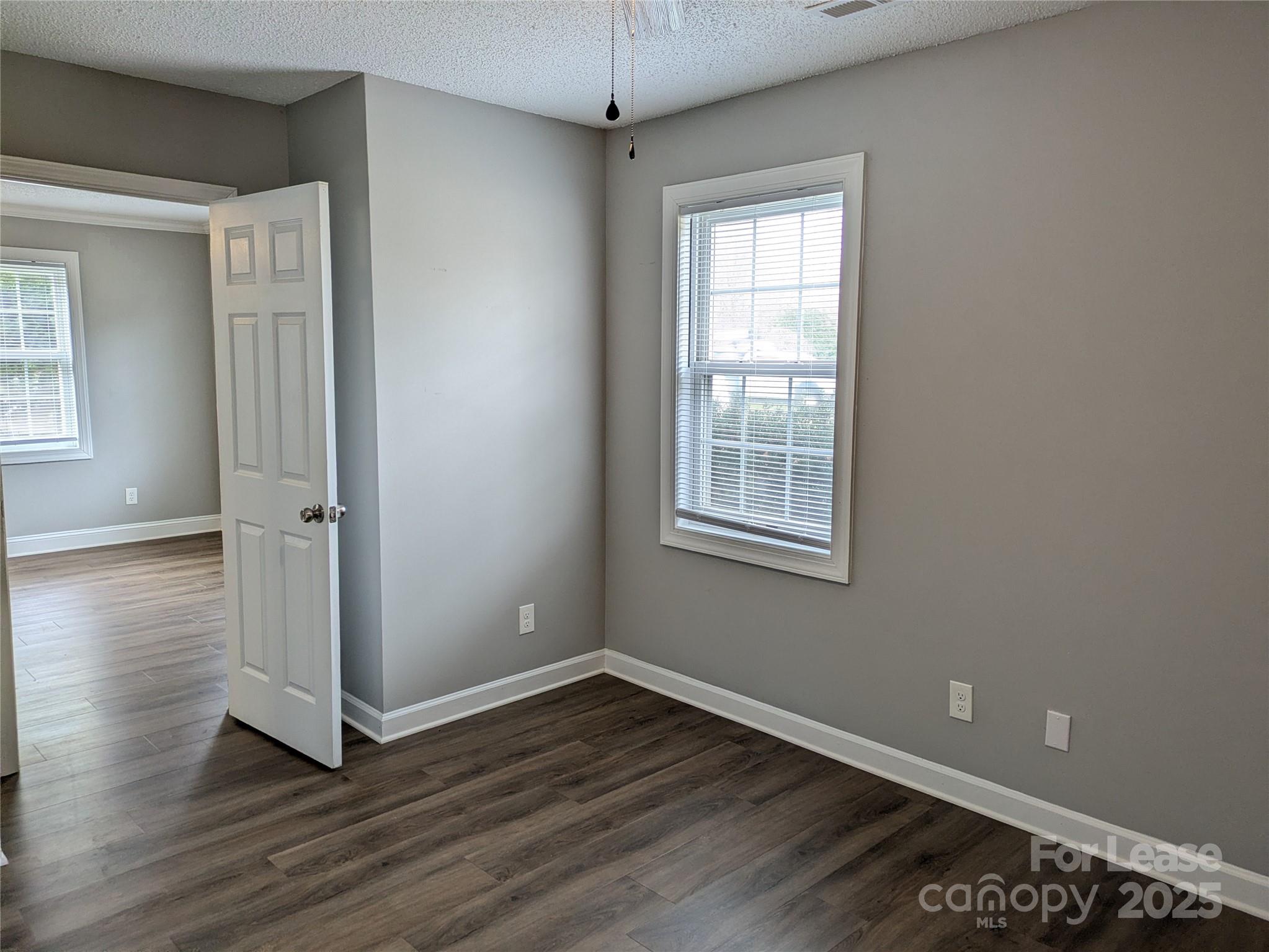 149 McKendree Road Mooresville, NC 28117 - Photo 6 of 21 an empty room with wooden floor and windows