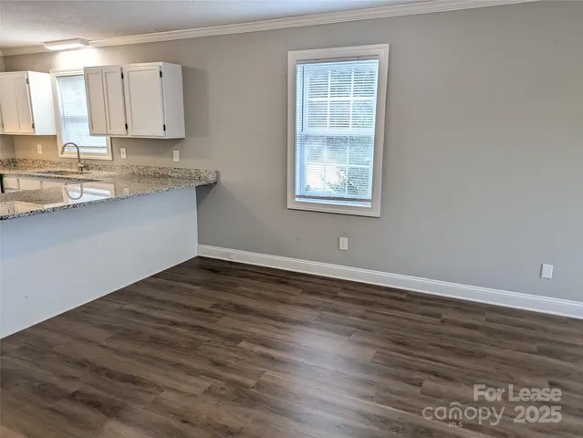 an empty room with wooden floor and a window