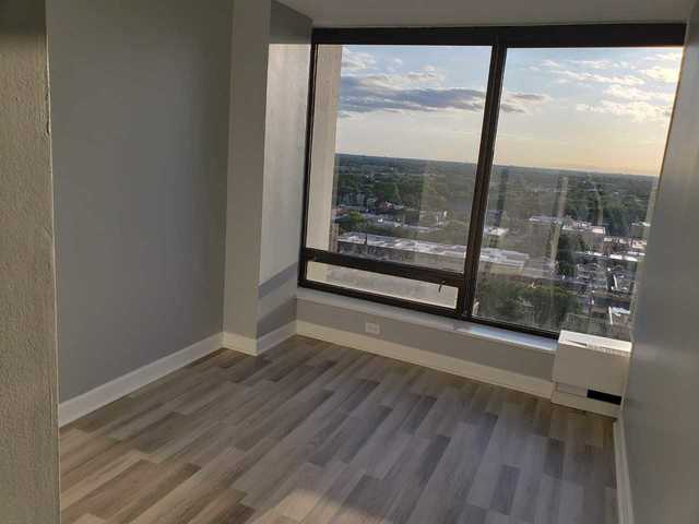 5445 North Sheridan Road, Unit 2005 Chicago, IL 60640 - Photo 15 of 19 a view of a room with wooden floor and windows