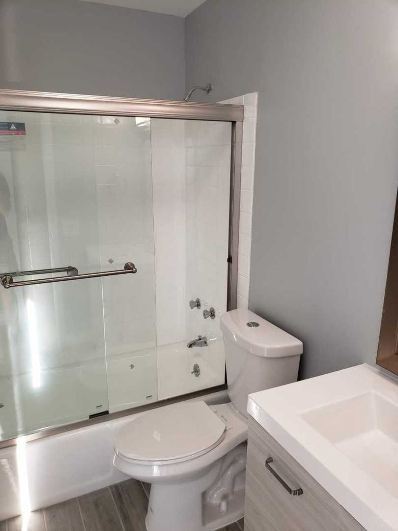 5445 North Sheridan Road, Unit 2005 Chicago, IL 60640 - Photo 16 of 19 a bathroom with a double vanity sink and toilet