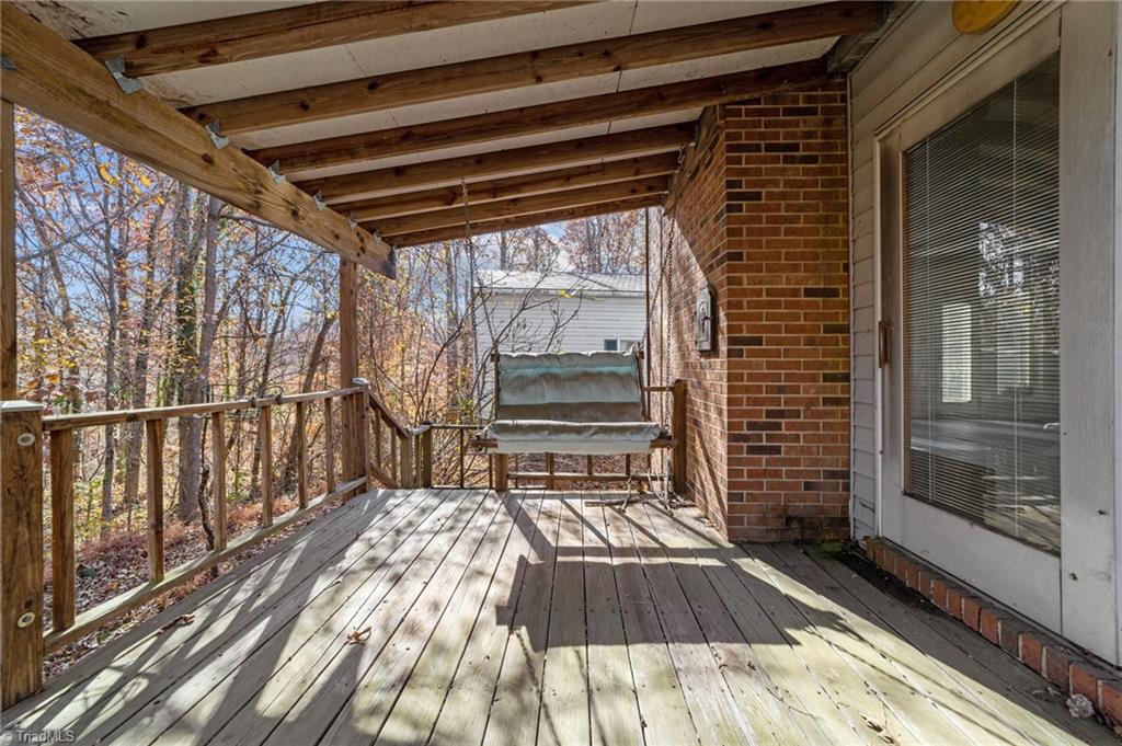 4532 Peeples Road Oak Ridge, NC 27310 - Photo 11 of 49 Back deck can be accessed from the den/sunroom on the main floor.