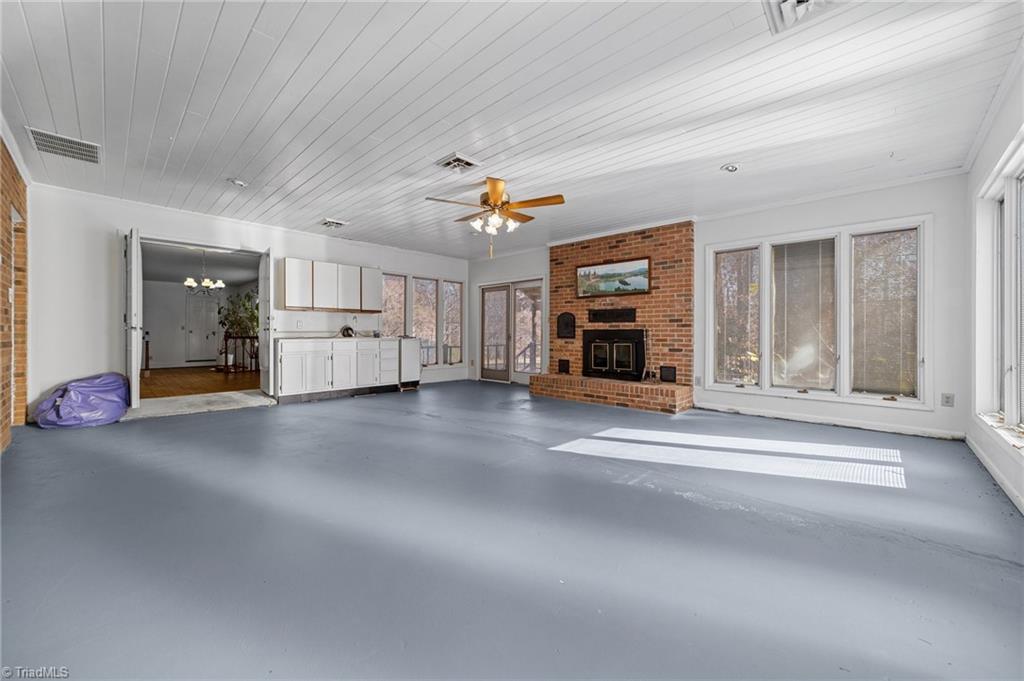 4532 Peeples Road Oak Ridge, NC 27310 - Photo 21 of 49 Den/Sunroom. Access to back deck and side yard. Along with access to garage and dining area!