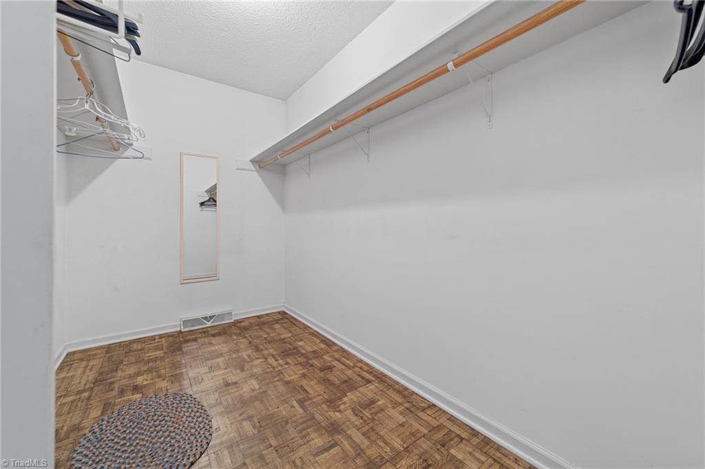 4532 Peeples Road Oak Ridge, NC 27310 - Photo 24 of 49 Walk in closet in the primary bedroom.