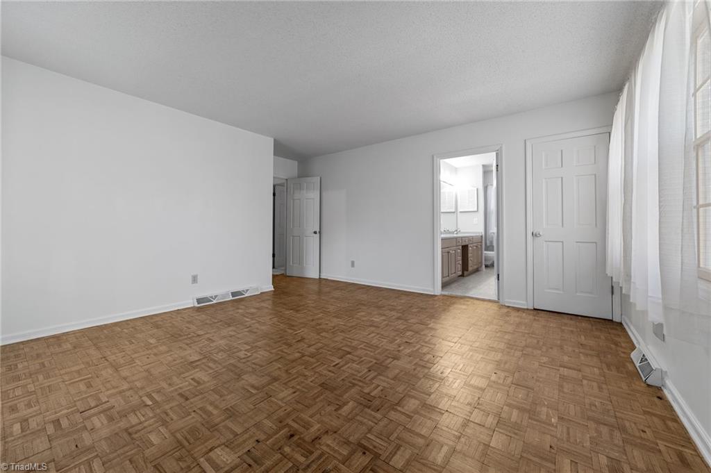 4532 Peeples Road Oak Ridge, NC 27310 - Photo 25 of 49 Primary bedroom with an ensuite bathroom on the main floor.