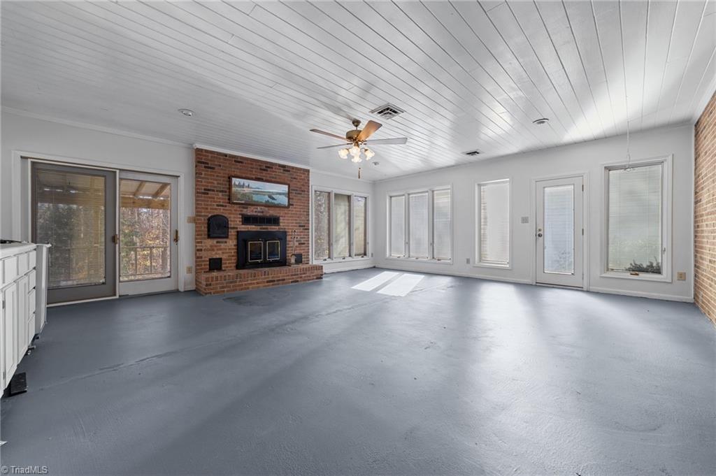 4532 Peeples Road Oak Ridge, NC 27310 - Photo 5 of 49 Huge sunroom/den with fireplace on the main floor.