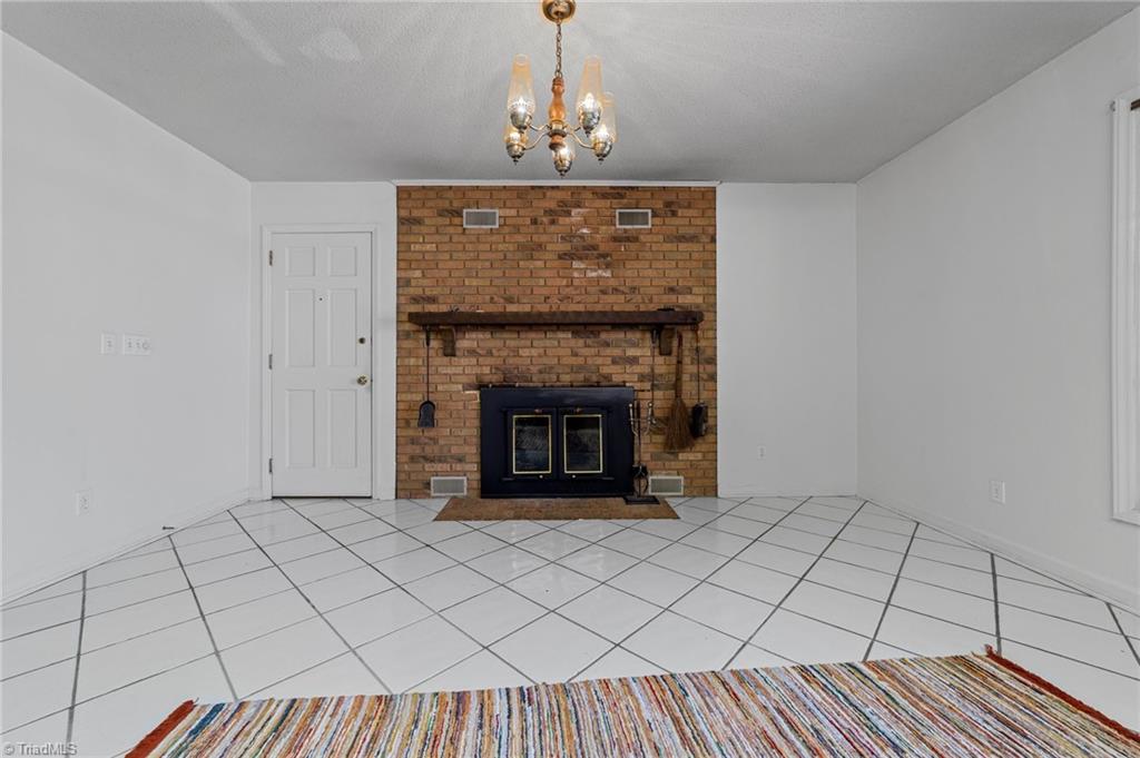 4532 Peeples Road Oak Ridge, NC 27310 - Photo 6 of 49 Breakfast nook with fireplace and door to the garage