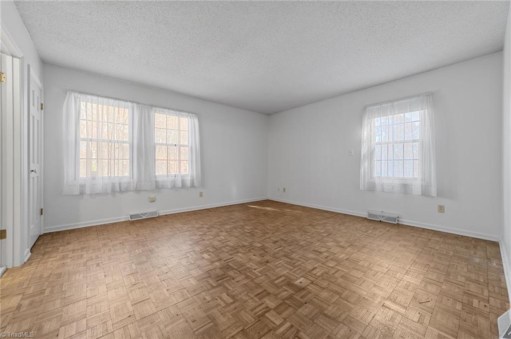 4532 Peeples Road Oak Ridge, NC 27310 - Photo 7 of 49 Primary bedroom with great natural light and large walk in closet.