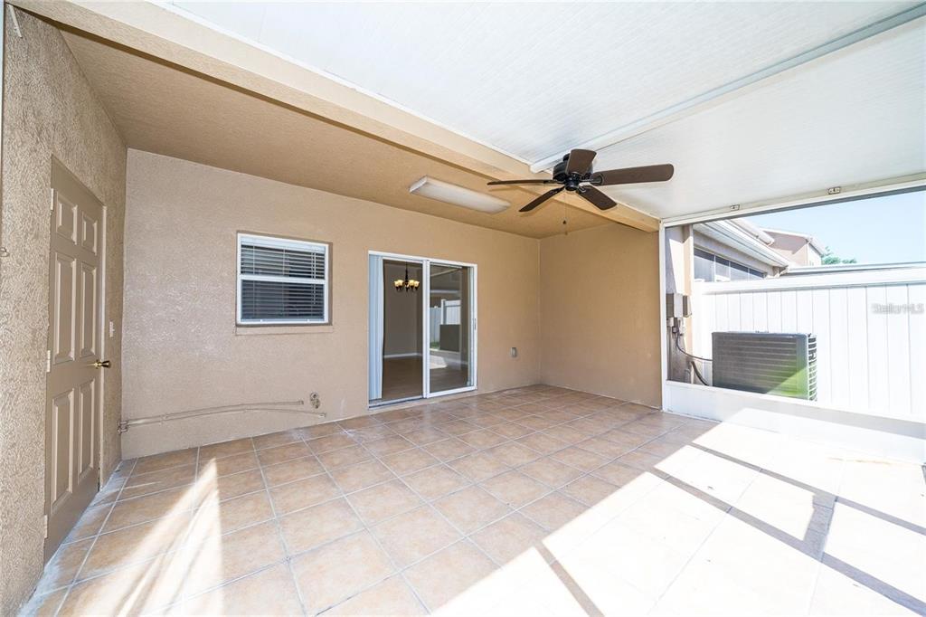 1238 Beckenham Way Wesley Chapel, FL 33543 - Photo 14 of 31 a view of a livingroom with wooden floor and a ceiling fan