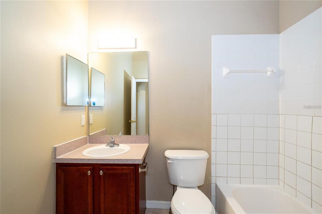 1238 Beckenham Way Wesley Chapel, FL 33543 - Photo 18 of 31 a bathroom with a sink a toilet and shower