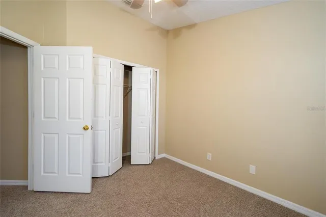 an empty room with closet area