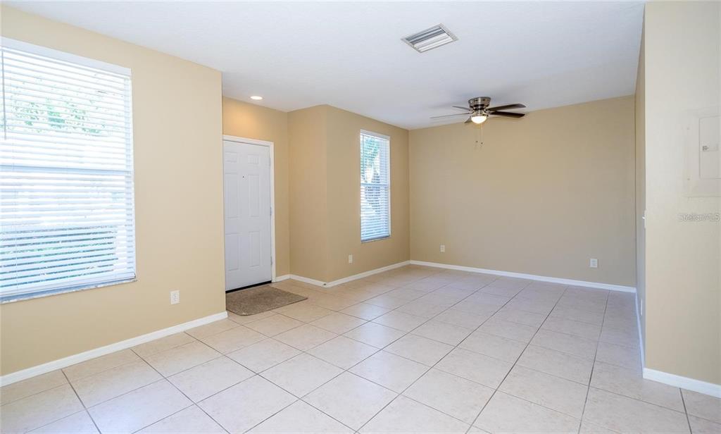 1238 Beckenham Way Wesley Chapel, FL 33543 - Photo 4 of 31 an empty room with windows