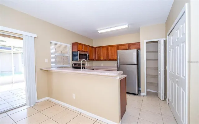 a kitchen with stainless steel appliances granite countertop a refrigerator and a sink