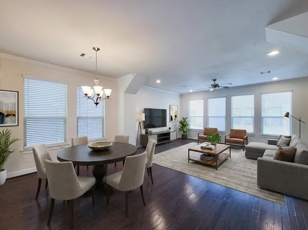 a view of a dining room with furniture wooden floor and chandelier