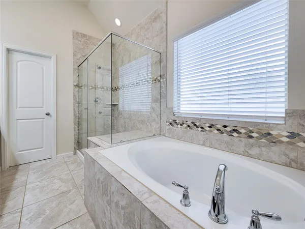 a bathroom with a bathtub and a shower