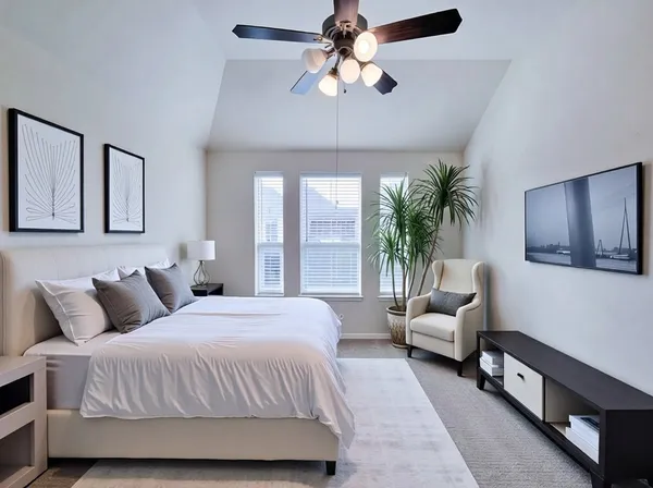 a bedroom with a large bed couch and a window