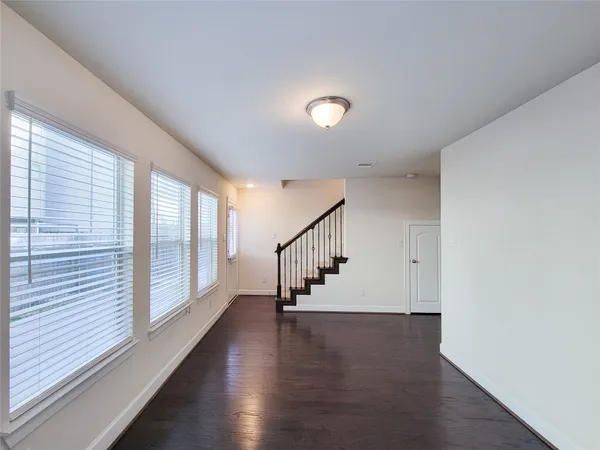 a view of staircase with wooden floor and a window