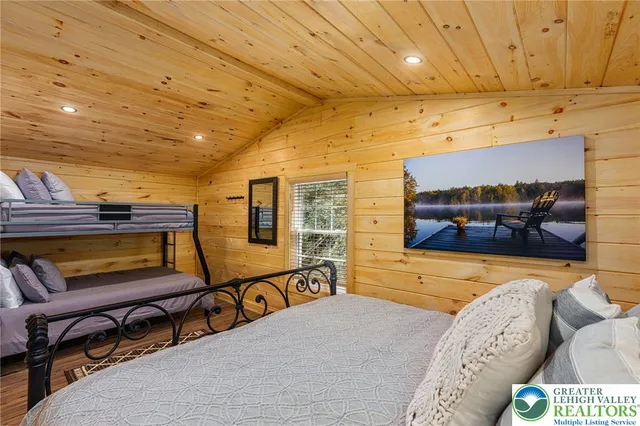 a bedroom with furniture and wooden floor