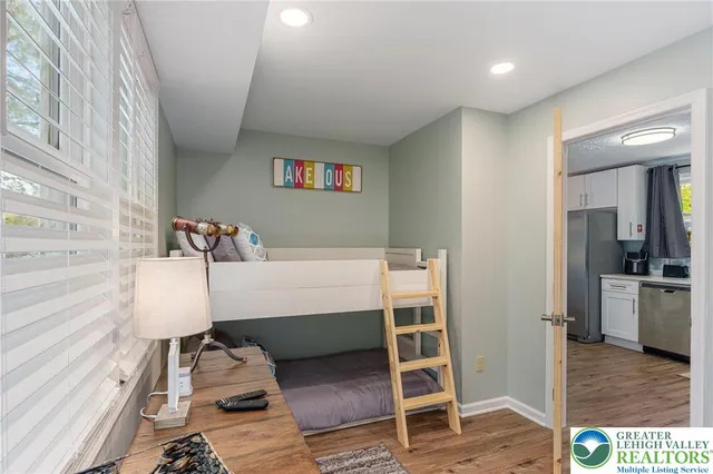 a living room with a couch and a table with wooden floor