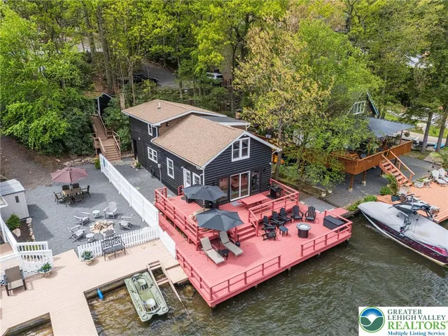 a view of a lake with boats and large trees