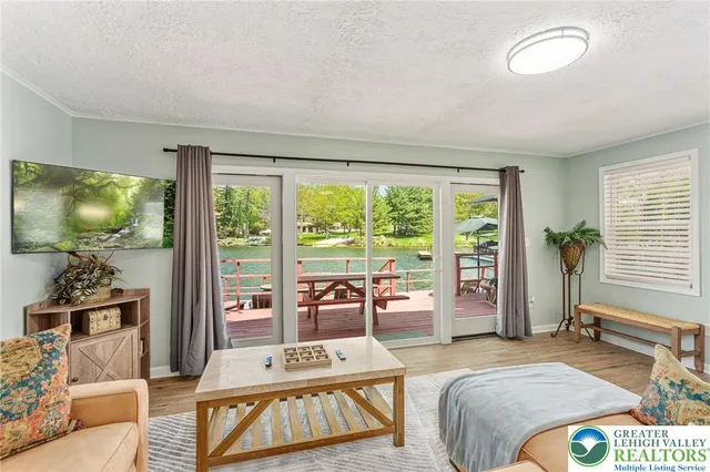 a bedroom with a bed and a flat tv screen next to a window
