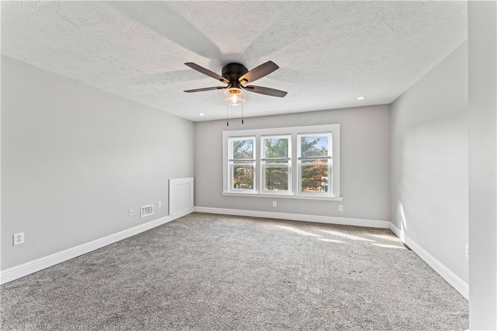 532 Park Road Ambridge, PA 15003 - Photo 27 of 37 an empty room with chandelier fan and windows