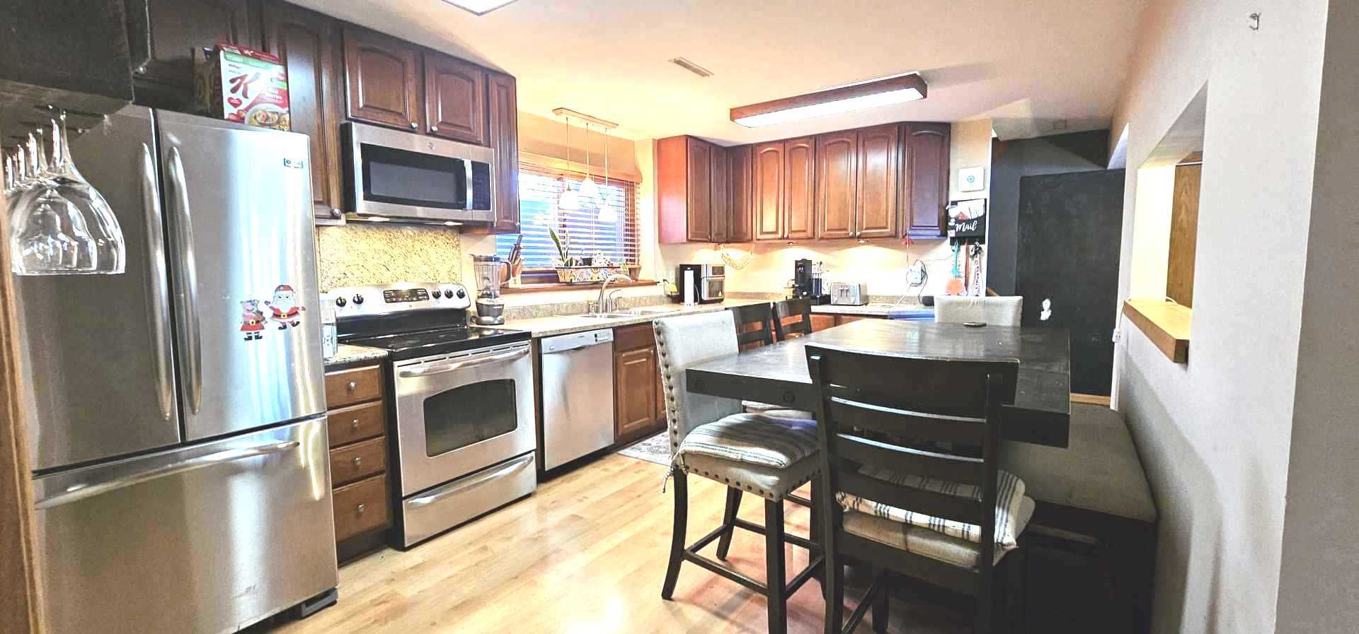 968 Coventry Lane Crystal Lake, IL 60014 - Photo 13 of 19 a kitchen with stainless steel appliances granite countertop a refrigerator stove microwave and sink
