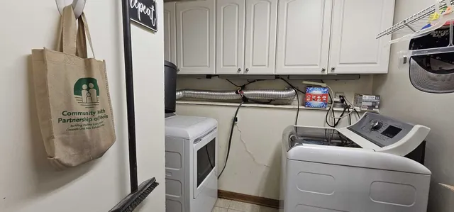 a view of storage and utility room with washer and dryer