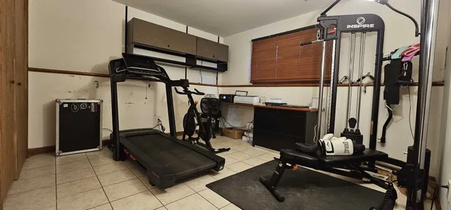 a room with gym equipment and a mirror