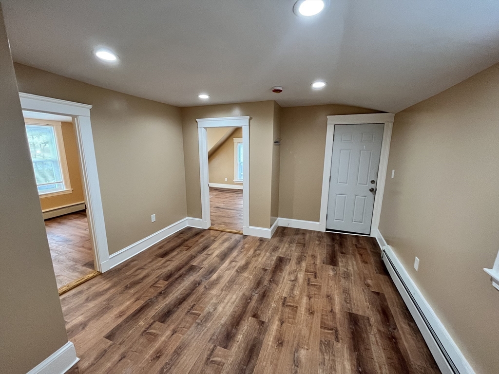 11 Benefit Terrace, Unit 3 Worcester, MA 01610 - Photo 11 of 15 a view of an empty room and wooden floor