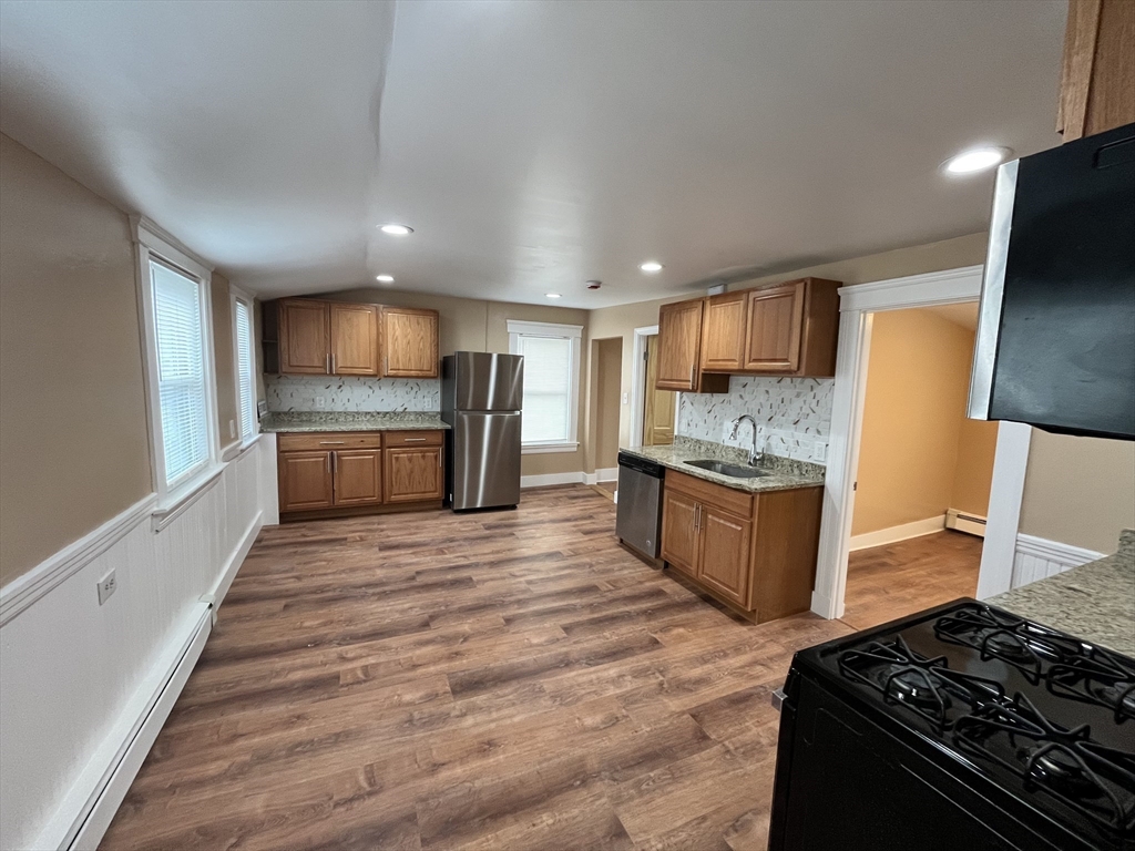 11 Benefit Terrace, Unit 3 Worcester, MA 01610 - Photo 4 of 15 a kitchen with stainless steel appliances granite countertop a stove and a refrigerator