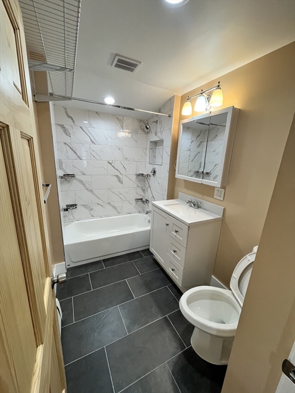 11 Benefit Terrace, Unit 3 Worcester, MA 01610 - Photo 5 of 15 a bathroom with a sink a toilet and shower