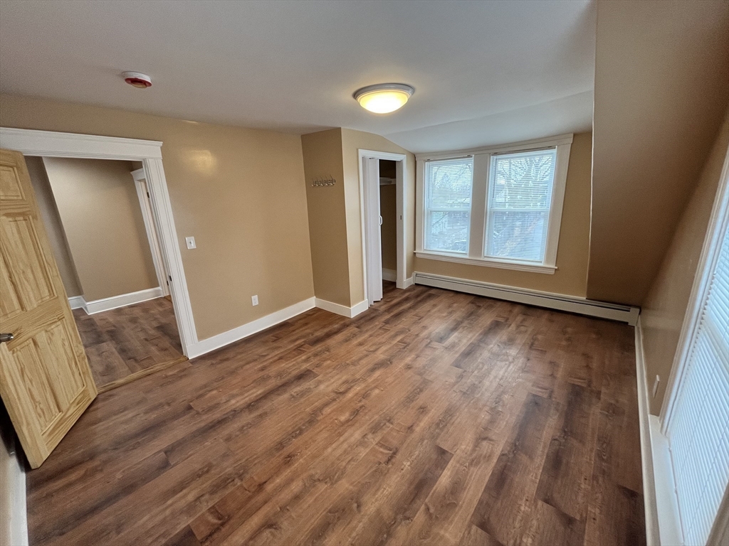 11 Benefit Terrace, Unit 3 Worcester, MA 01610 - Photo 6 of 15 a view of an empty room with wooden floor and a window