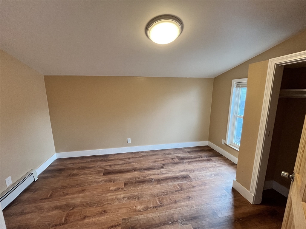 11 Benefit Terrace, Unit 3 Worcester, MA 01610 - Photo 8 of 15 an empty room with wooden floor and windows