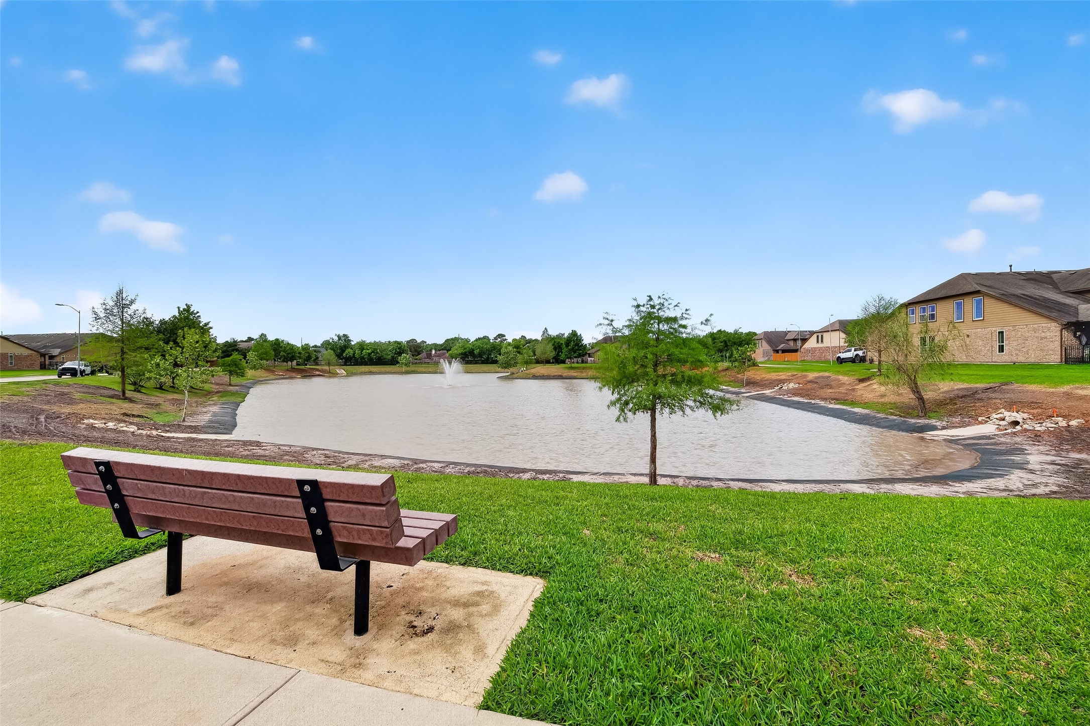 24122 Valencia Ridge Lane Katy, TX 77494 - Photo 44 of 46 Scenic community pond with walking trails, mature trees, and peaceful green space provides a beautiful outdoor escape close to home.
