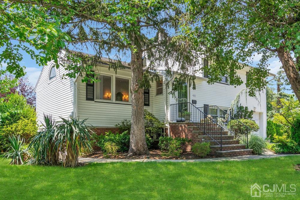 a view of a house with a yard and plants