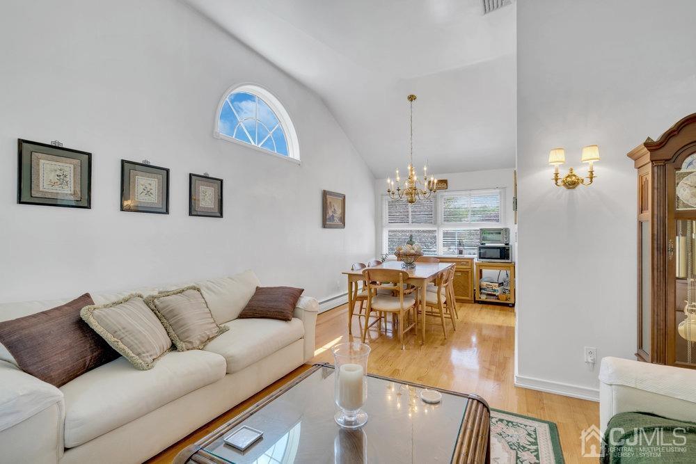 233 Amherst Avenue Colonia, NJ 07067 - Photo 17 of 56 a living room with furniture and a chandelier