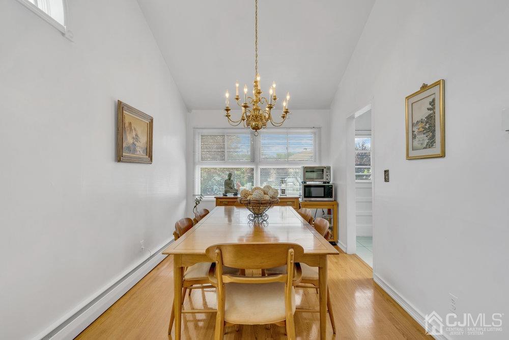 233 Amherst Avenue Colonia, NJ 07067 - Photo 18 of 56 a view of a dining room with furniture and chandelier