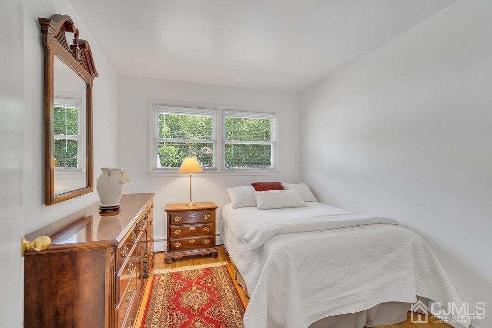 233 Amherst Avenue Colonia, NJ 07067 - Photo 20 of 56 a bedroom with two beds and a window