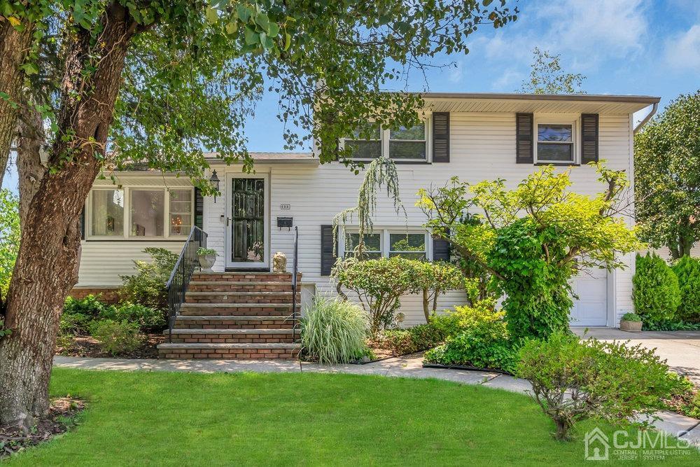233 Amherst Avenue Colonia, NJ 07067 - Photo 2 of 56 a front view of a house with a yard